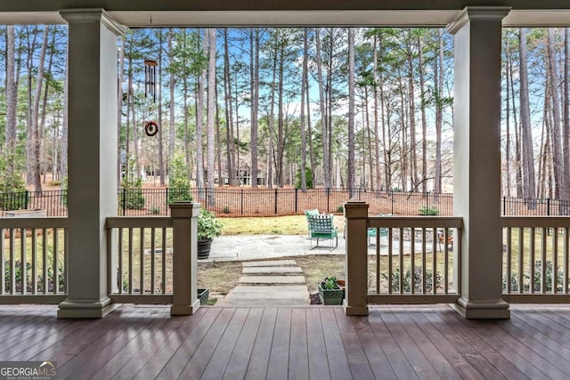 deck featuring a patio area and fence