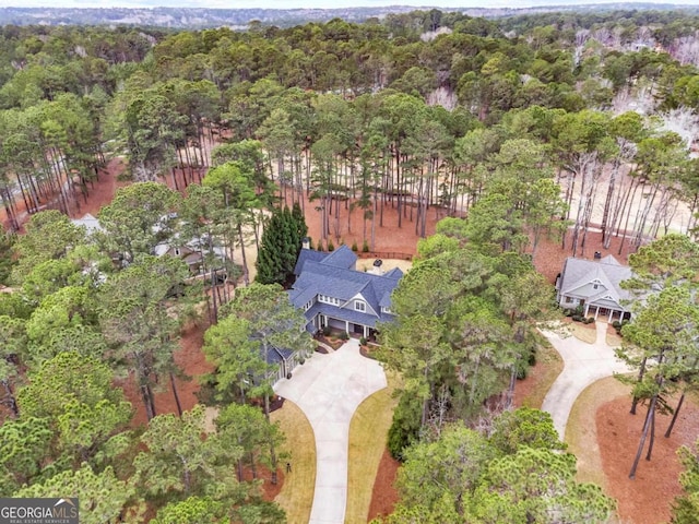 aerial view featuring a wooded view