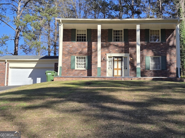 view of front of home featuring a garage, a front yard, and brick siding