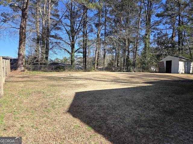 view of yard with an outdoor structure and fence