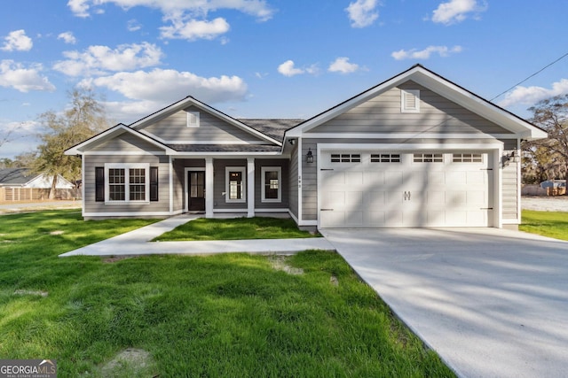 view of front of property with a garage, covered porch, concrete driveway, and a front yard