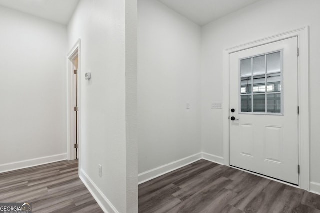 entryway featuring baseboards and dark wood-style floors