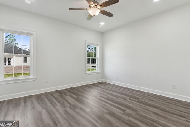 spare room with recessed lighting, a ceiling fan, baseboards, and dark wood-style flooring