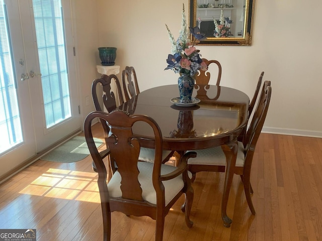 dining room featuring hardwood / wood-style flooring and baseboards