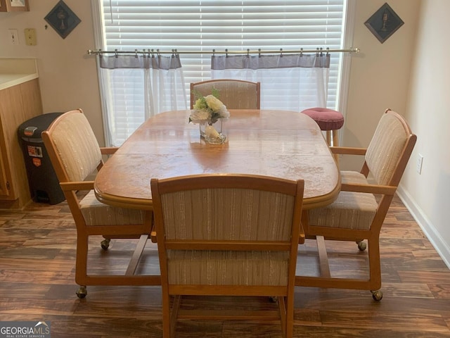 dining area featuring plenty of natural light, wood finished floors, and baseboards