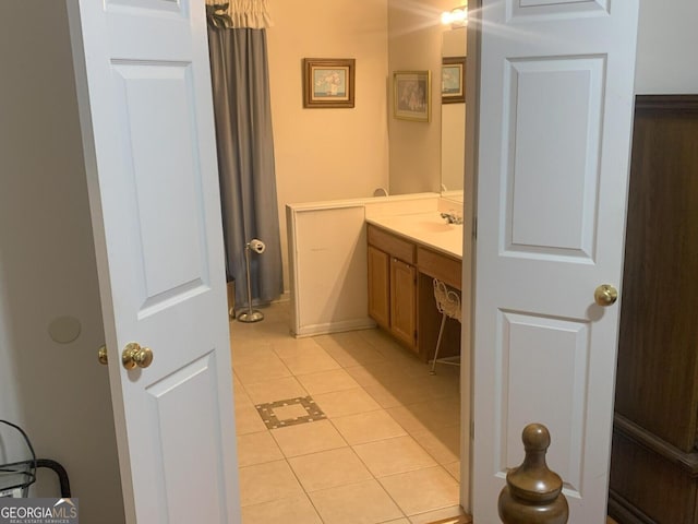 bathroom featuring tile patterned flooring and vanity