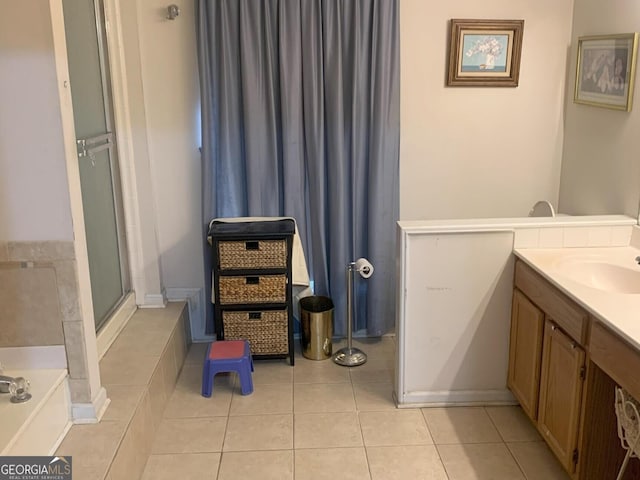 full bathroom with a bath, a shower with shower door, tile patterned flooring, and vanity