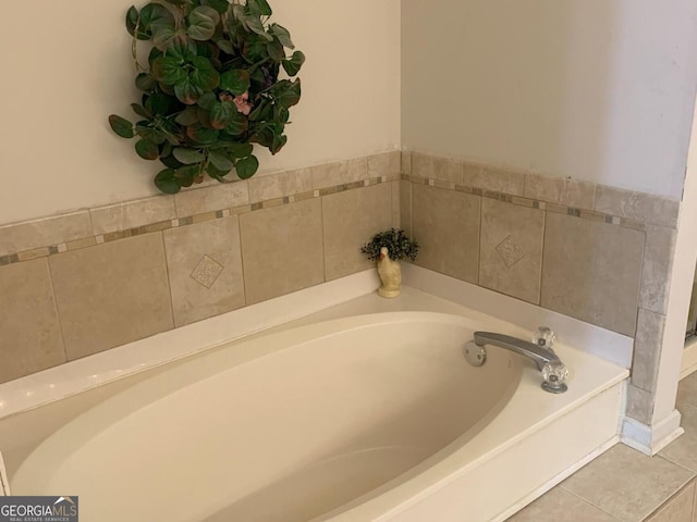 full bath with a garden tub and tile patterned floors