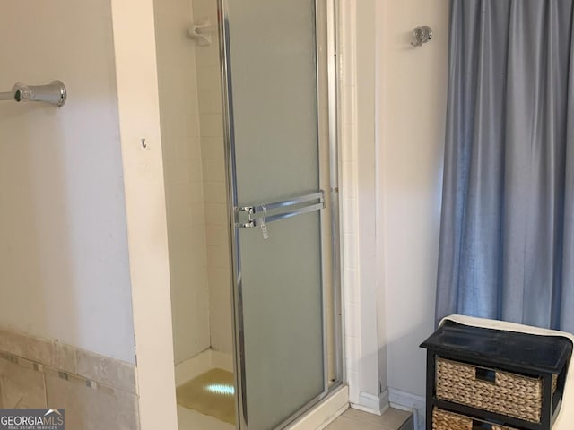 bathroom featuring a shower stall and tile patterned floors