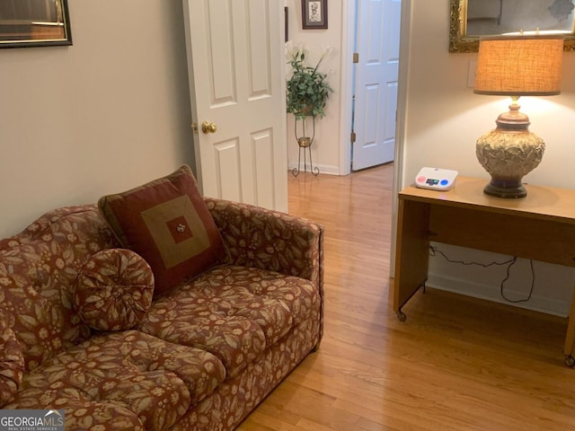 sitting room with wood finished floors and baseboards