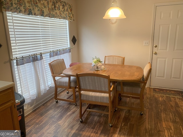 dining space with wood finished floors