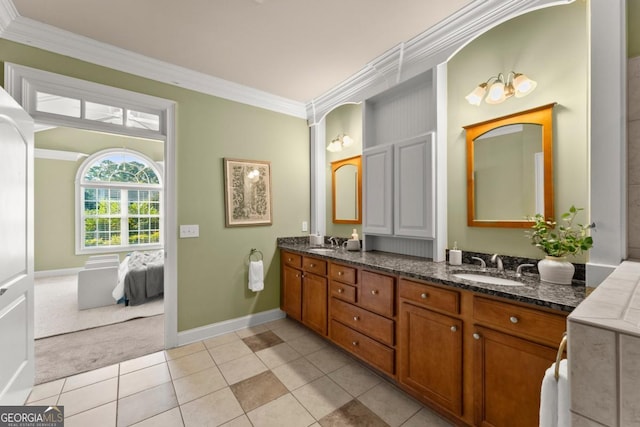 full bath featuring double vanity, crown molding, a sink, and tile patterned floors