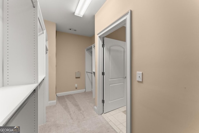 walk in closet featuring light carpet and visible vents