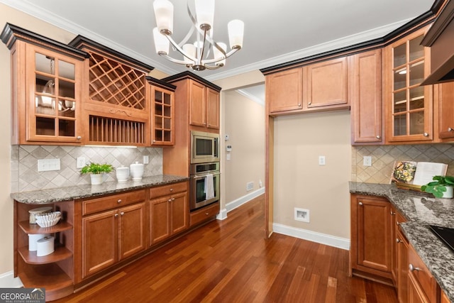 kitchen featuring appliances with stainless steel finishes, brown cabinetry, dark wood-type flooring, and ornamental molding