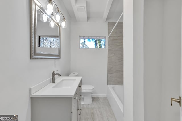 bathroom with marble finish floor, vanity, and toilet