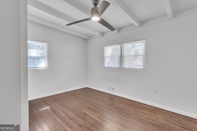 spare room featuring visible vents, ceiling fan, wood finished floors, beamed ceiling, and baseboards