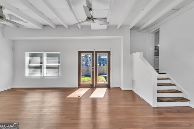 interior space with a ceiling fan, beamed ceiling, and wood finished floors