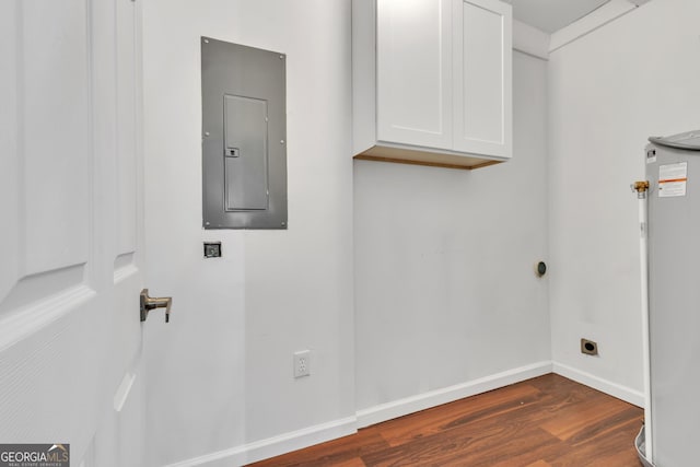 washroom with dark wood-style flooring, cabinet space, hookup for an electric dryer, electric panel, and baseboards