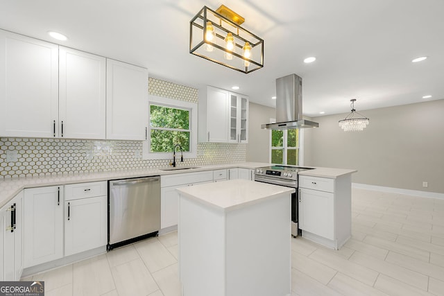 2682 Miriam Ln, Decatur, GA 30032 - kitchen with stainless steel appliances, island range hood, a sink, a peninsula, and tasteful backsplash