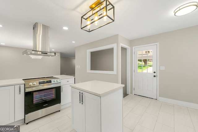 kitchen with electric stove, light countertops, white cabinetry, and island range hood