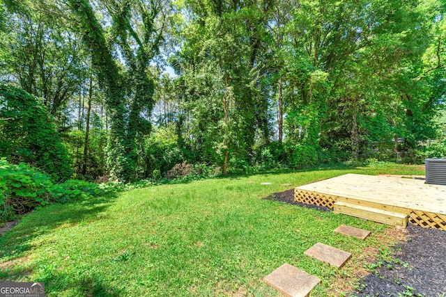 view of yard featuring central AC and a deck