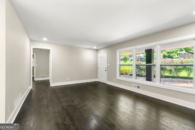 empty room featuring visible vents and baseboards