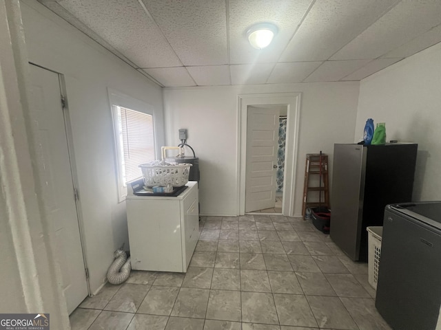 laundry area with laundry area, light tile patterned flooring, and separate washer and dryer