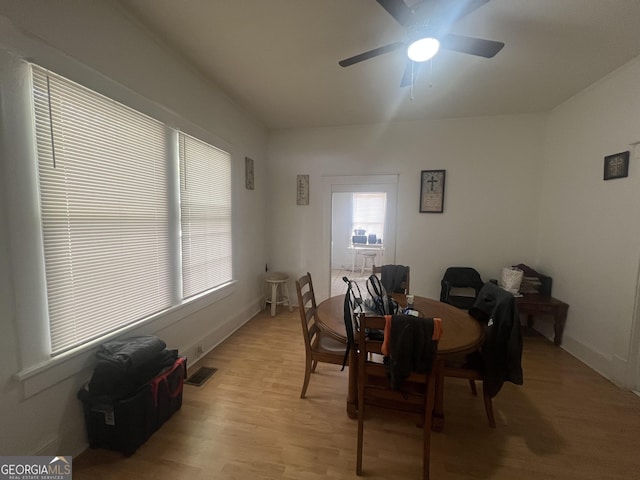 dining area with a ceiling fan, visible vents, and light wood-style flooring