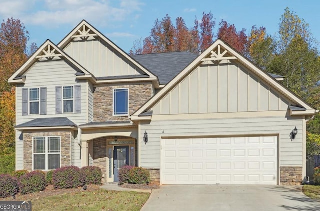 craftsman-style house with a garage, stone siding, and board and batten siding