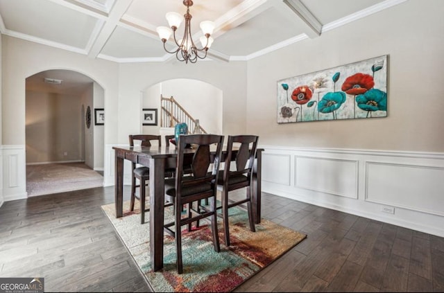 dining room featuring a chandelier, arched walkways, coffered ceiling, and dark wood finished floors