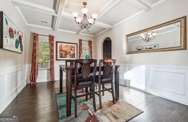 dining room featuring an inviting chandelier, visible vents, arched walkways, and beam ceiling