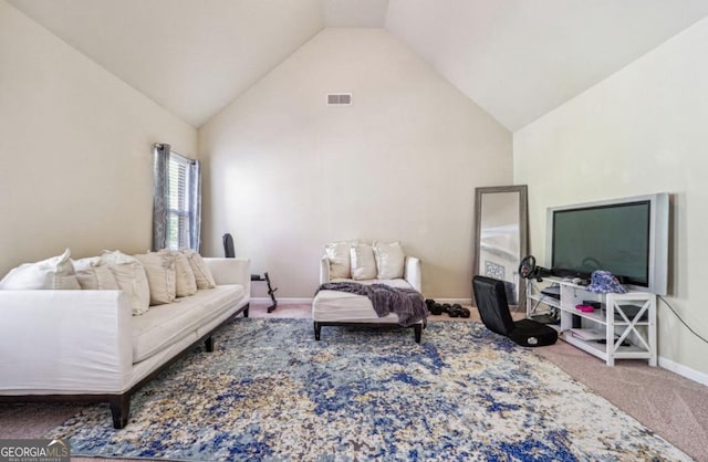 carpeted living area with high vaulted ceiling, visible vents, and baseboards