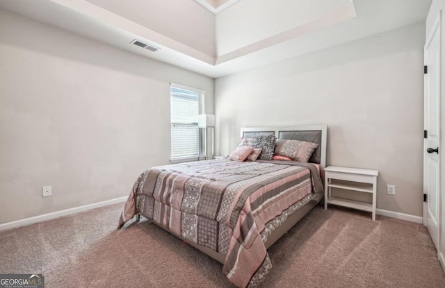 carpeted bedroom featuring baseboards and visible vents