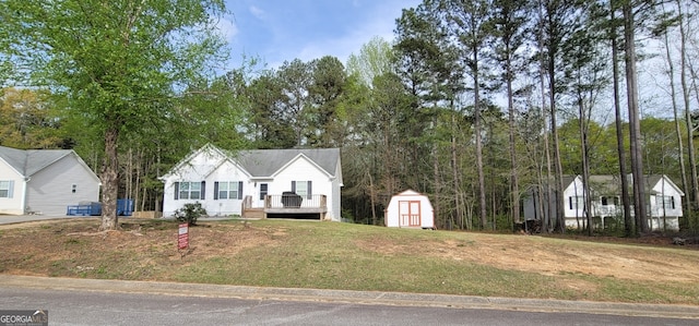 220 Joe Dr, Temple, GA 30179 - view of front facade featuring an outbuilding, a storage shed, a front yard, and a deck