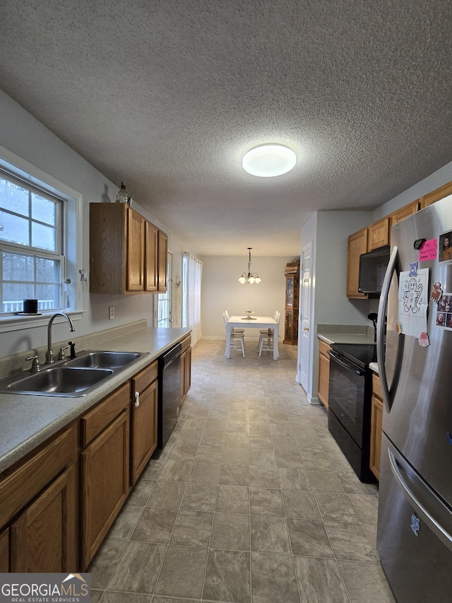 220 Joe Dr, Temple, GA 30179 - kitchen featuring a notable chandelier, a sink, hanging light fixtures, brown cabinets, and black appliances
