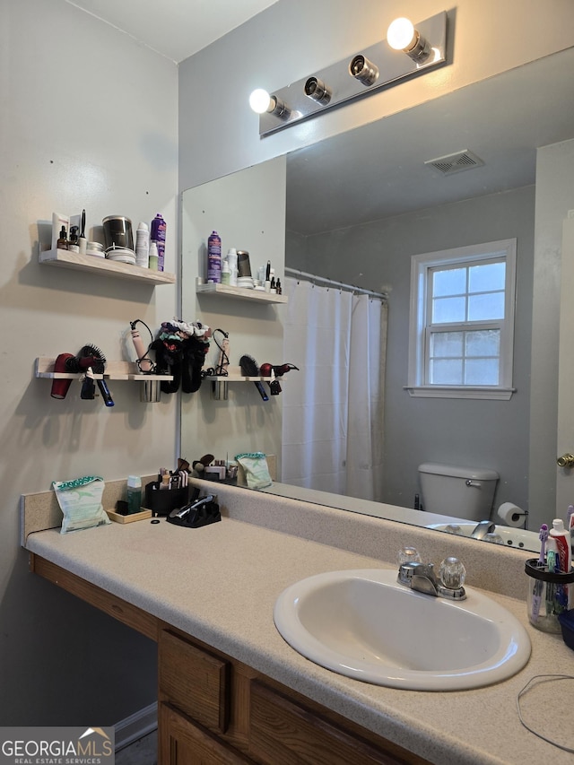 220 Joe Dr, Temple, GA 30179 - full bathroom featuring visible vents, toilet, vanity, and a shower with curtain