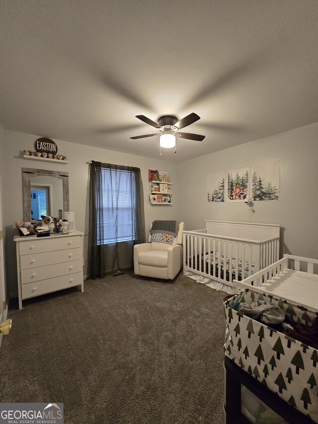220 Joe Dr, Temple, GA 30179 - bedroom with a crib, ceiling fan, and dark colored carpet