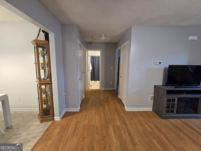 220 Joe Dr, Temple, GA 30179 - hall with baseboards, a textured ceiling, and wood finished floors