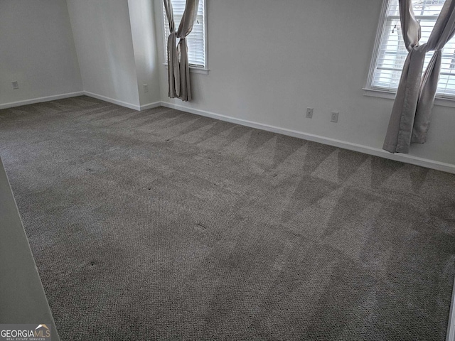 interior space with baseboards and carpet flooring