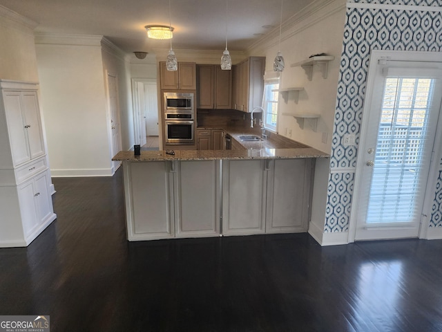 kitchen with ornamental molding, open shelves, appliances with stainless steel finishes, and a sink