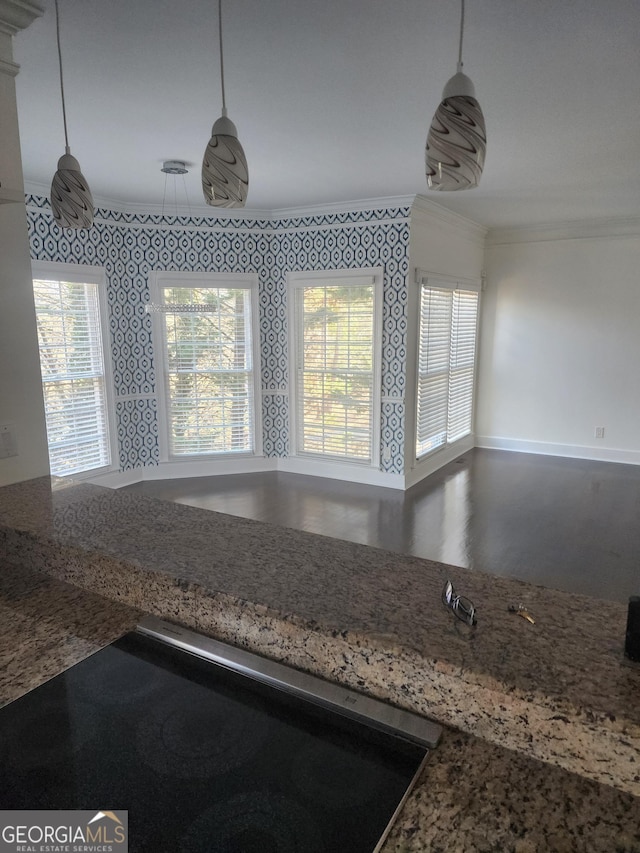 room details with black electric cooktop, baseboards, hanging light fixtures, ornamental molding, and wallpapered walls