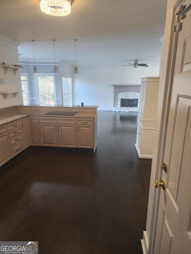 kitchen with ceiling fan, dark wood-type flooring, decorative light fixtures, a stone fireplace, and open shelves