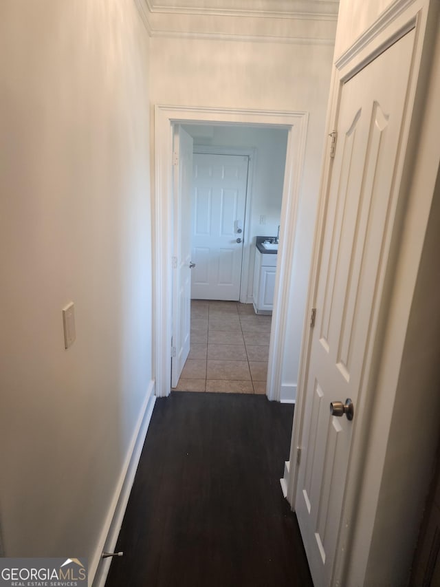 hallway with tile patterned flooring and baseboards