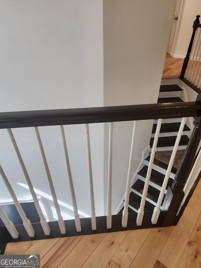 staircase featuring wood finished floors