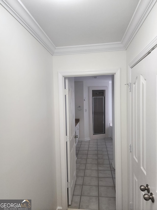 hallway featuring light tile patterned floors and crown molding