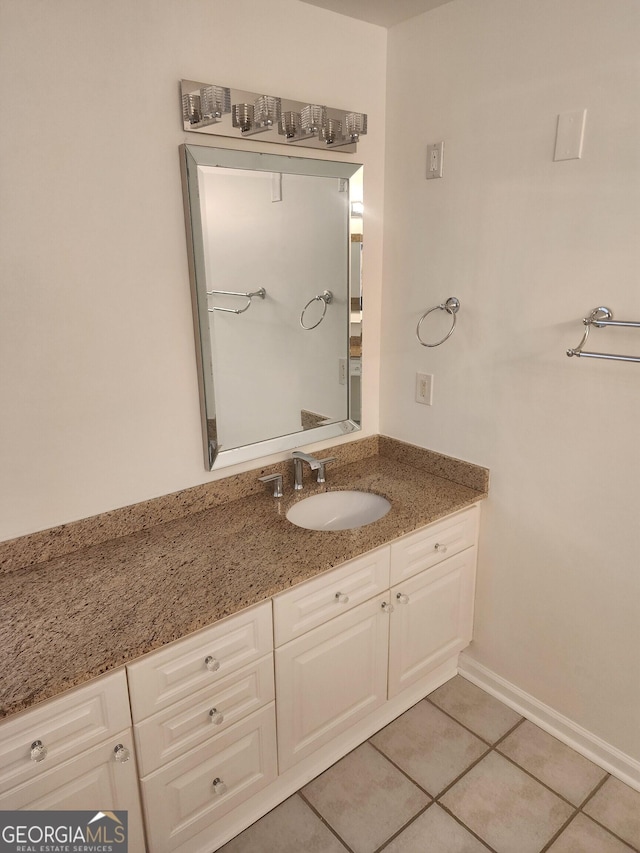 bathroom featuring vanity, baseboards, and tile patterned floors