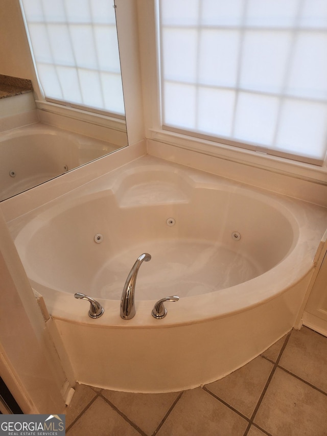 full bathroom with a whirlpool tub and tile patterned flooring