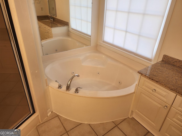 full bath with a tub with jets, tile patterned flooring, and vanity