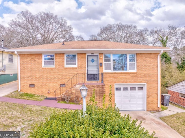 view of front of house with brick siding, concrete driveway, an attached garage, crawl space, and stairs