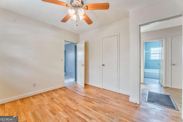 unfurnished bedroom with a ceiling fan, baseboards, and wood finished floors